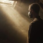 A homeowner realizing the hidden dangers of DIY asbestos removal in Shreveport, showing how common masks fail to protect against toxic airborne fibers.
